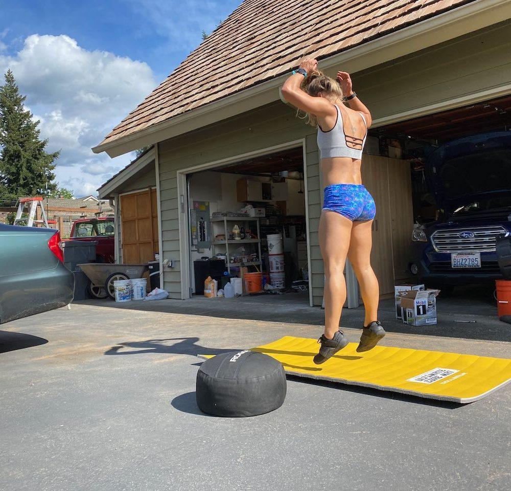 Emily doing burpees in an at-home workout in the driveway