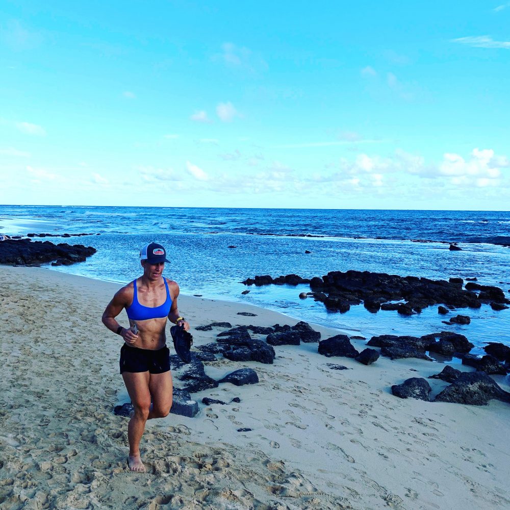 Emily running on the beach in Kauai